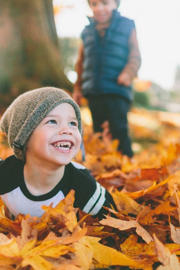 child playing in leaves in New England