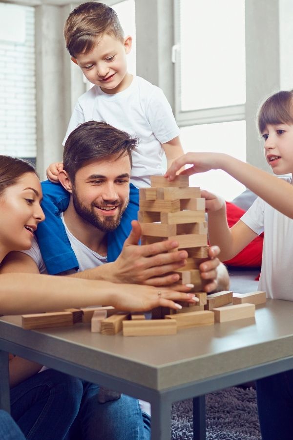 family playing a game - add it to your family bucket list